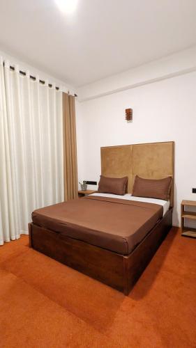 a bedroom with a large bed in a room at Blue Waters Edge - Kandy in Kande