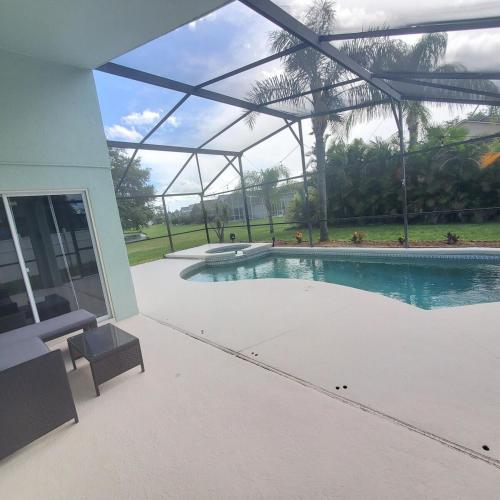 a swimming pool in a house with a building at Family Getaway by Disney! in Kissimmee