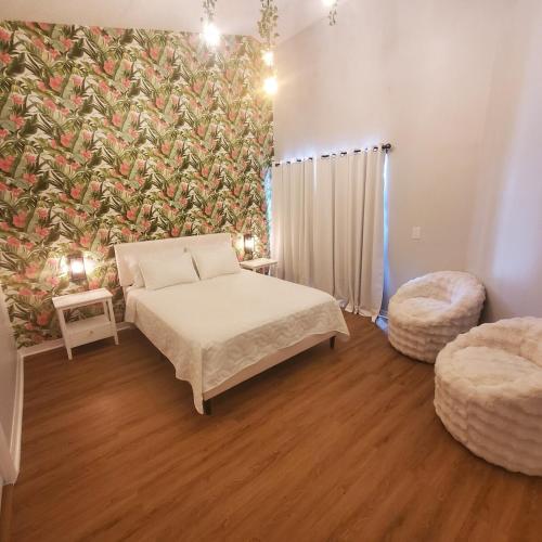 a bedroom with a bed and a large mural at Family Getaway by Disney! in Kissimmee