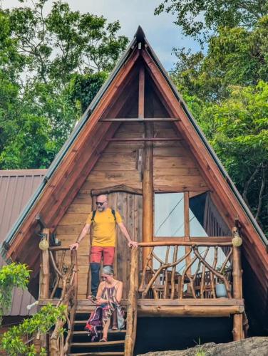 a man standing on the stairs of a tree house at Nature World Jungle Paradise in Udawalawe