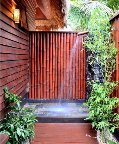 a wooden fence with a water fountain at Cauayan Island Resort and Spa in El Nido