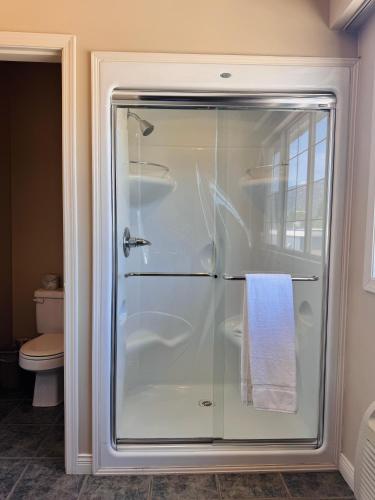 a shower with a glass door in a bathroom at Super 8 by Wyndham Castlegar BC in Castlegar