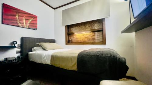 a bedroom with a bed and a window at Room 78 in Coquimbo