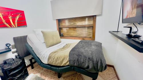 a small bed in a room with a window at Room 78 in Coquimbo