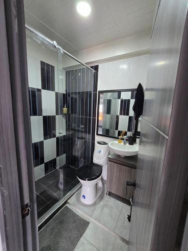 a bathroom with a toilet and a shower and a sink at Pipe's House in Salento