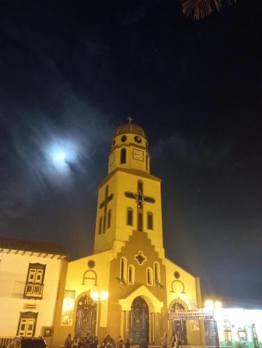 a church building with a clock tower at night at Pipe's House in Salento