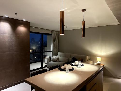 a kitchen and living room with a couch and a table at Lindo apartamento em São Paulo in Sao Paulo