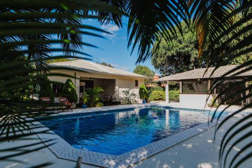 a swimming pool in front of a house at Luxury Oasis in Las Colinas- Elegant 3-Bedroom Villa in Managua