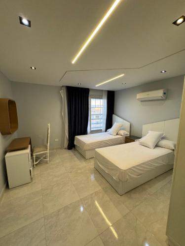 a hotel room with two beds and a television at Best view in Port Said