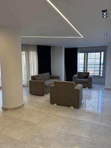 a lobby with couches and chairs in a building at Best view in Port Said