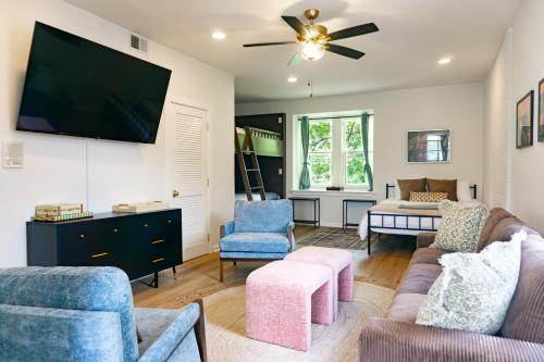 a living room with a couch and a flat screen tv at Red Brick Row by StayLage in Saint Louis