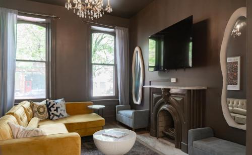 a living room with a couch and a fire place at Red Brick Row by StayLage in Saint Louis