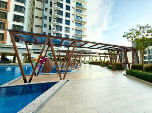 a wooden bridge over a swimming pool in a building at K avenue condominium Studio in Donggongon