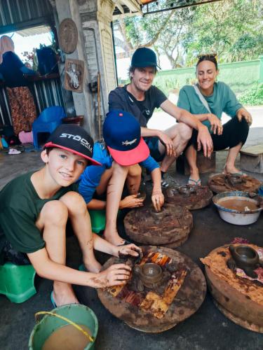 a group of people sitting around a table with food at Vaniglia House Tetebatu in Tetebatu