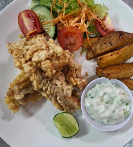 a plate of food with chicken and a salad and dip at Abian Klumpu Villa & Spa Sanur Bali in Sanur