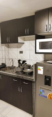 a kitchen with a counter with pots and pans at Departamento centro in Andahuaylas