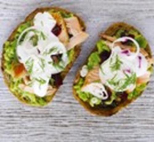 two small pizzas with lettuce and dressing on a table at Abian Klumpu Villa & Spa Sanur Bali in Sanur