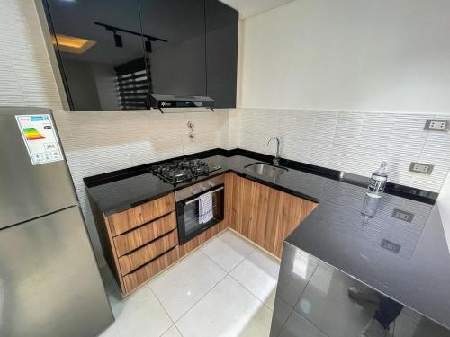 a small kitchen with a sink and a stove at Very cozy apartment in Santa Cruz de la Sierra