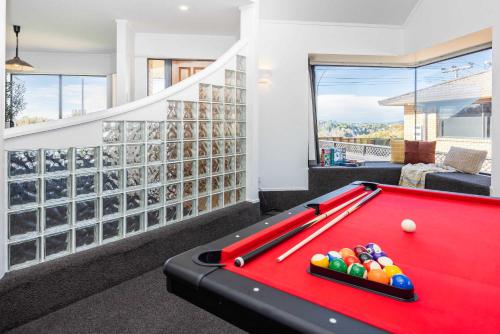 a living room with a red pool table at Great Short-Mid Term Stay! River Views & Games Room in Hamilton