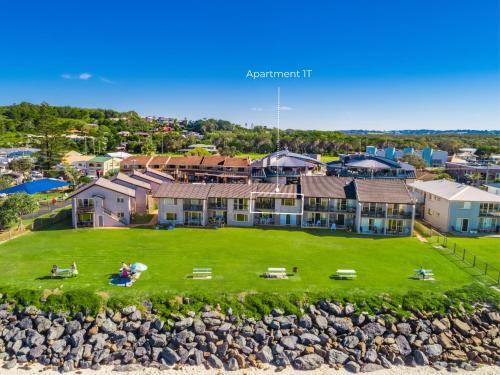 an aerial view of a house with a large yard at Absolute Beachfront Apartment 1T in Lennox Head