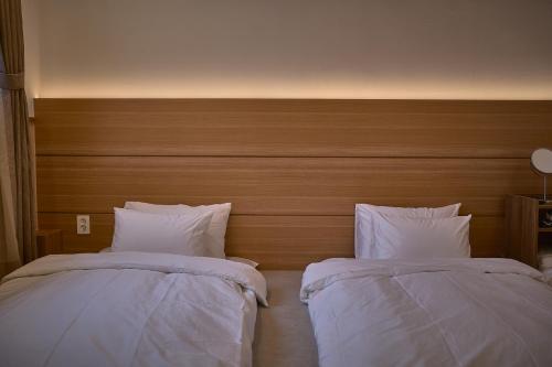 two beds sitting next to each other in a bedroom at Stay Libera in Gangneung