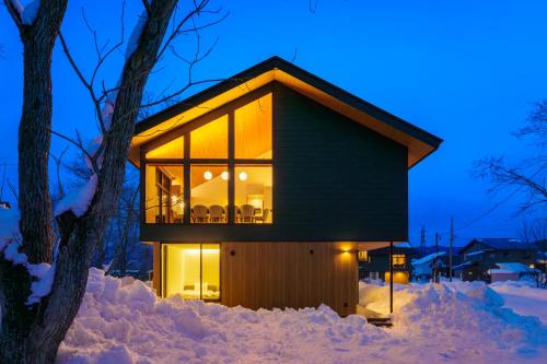 a house in the snow at night at Hakuba Amber Echoland MrT by Jade Villa in Hakuba