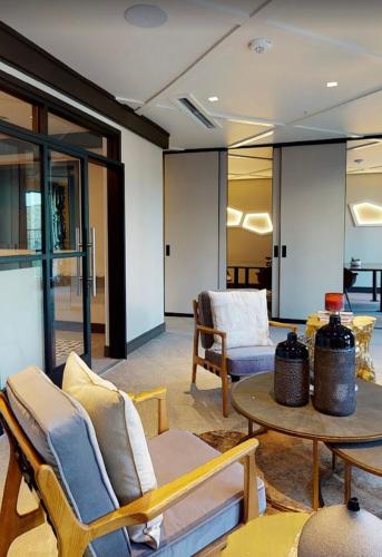 a living room with chairs and a table at The Link & Lounge, Close to Everything in Addison