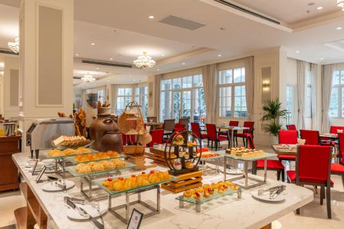 a buffet of food on a table in a lobby at Legend Valley Hotel Ha Nam in Phủ Lý