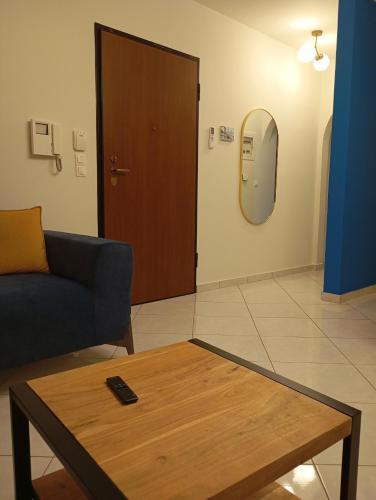a living room with a couch and a coffee table at Casa Azul Nea Makri in Nea Makri