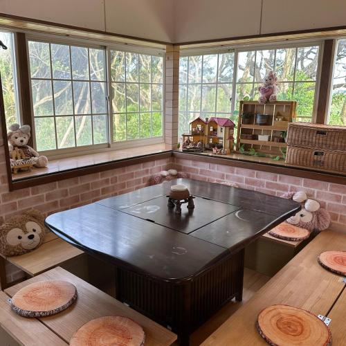a room with a table and some windows at With BBQ terrace & dog run A private house full of fun, right by the sea and surf spots in Kashima