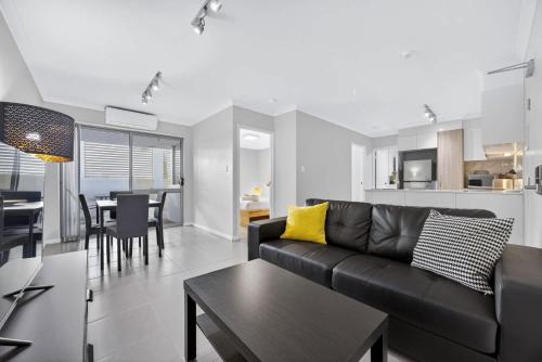 a living room with a couch and a dining room at Comfortable 2BR Stay in Rockingham in Rockingham