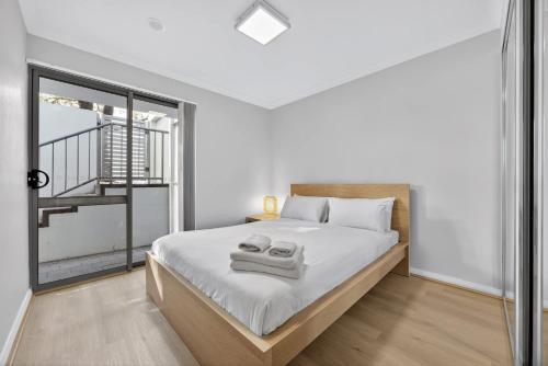 a bedroom with a large bed and a balcony at Comfortable 2BR Stay in Rockingham in Rockingham