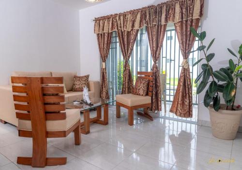 a living room with a couch and chairs and a window at Next to Basilica 3BR terrace wifi Punta Cana 30min in Higuey