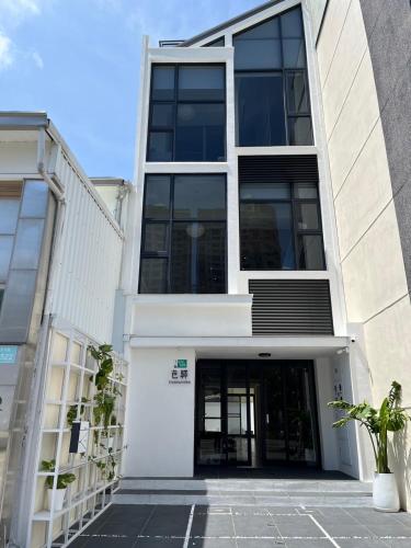 a large white building with a large glass door at 芭驛 8hundredmillion I 安平運河景觀住宿 in Anping
