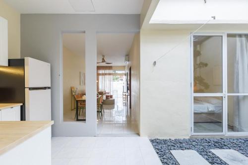 a kitchen with white walls and a dining room at De Luma-Cozy 2Bedroom Landed House, Bukit Mertajam in Bukit Mertajam