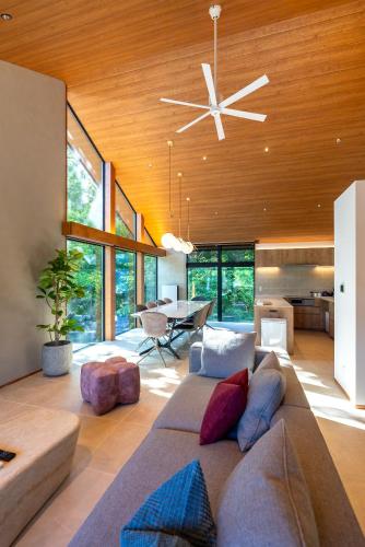 a living room with a couch and a ceiling fan at Amber MrT by Jade Group in Hakuba