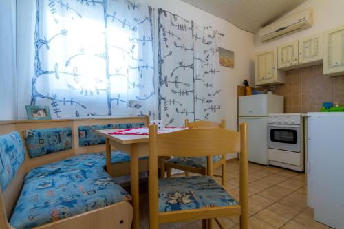 a small kitchen with a table and a table and chairs at Starigrad Apartment in Starigrad
