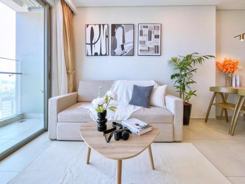 a living room with a couch and a coffee table at The Song Apartment 5 Stars Vung Tau - Căn Hộ Du Lịch 5 Sao Cạnh Biển - Dumin's Homestay in Vung Tau