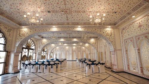 a row of chairs in a large room with a ceiling at Umaid Haveli-A Heritage Style Hotel & Resort in Jaipur