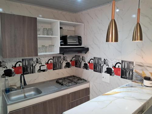 a kitchen with a sink and a stove at Hermoso y acogedor Apartamento en Neiva in Neiva