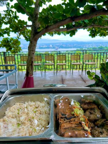 a container of food with rice and meat on a table at Castle View Hotel Samal in Magamomo