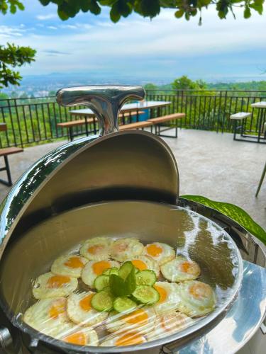 a pot of food with shrimp and vegetables in it at Castle View Hotel Samal in Magamomo