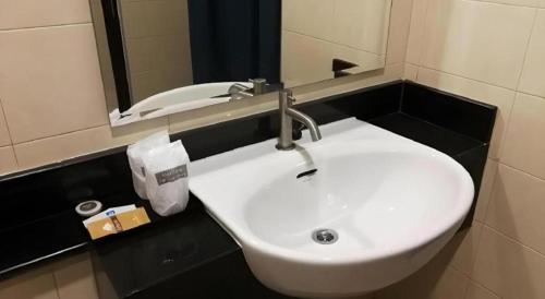 a white sink in a bathroom with a mirror at The Nest Krabi Hotel in Ao Nang Beach