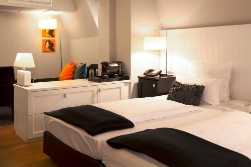 Säng eller sängar i ett rum på Hotel Victoria