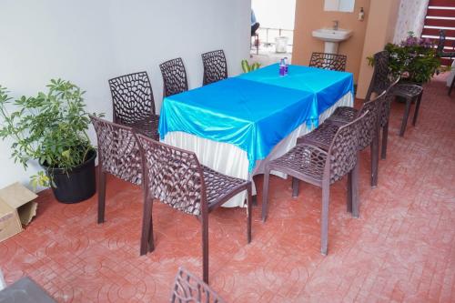 a table with chairs and a blue table cloth at Atithi Home Stay in Pune
