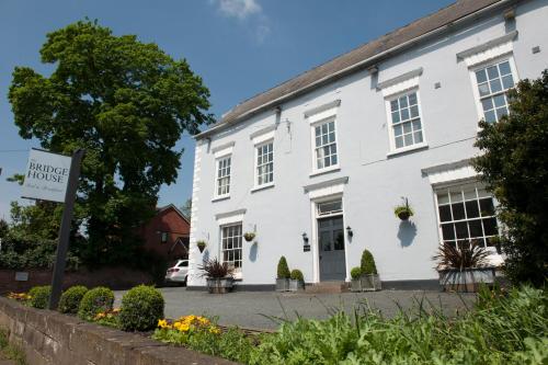 a white building with a sign in front of it at The Bridge House in Ross on Wye