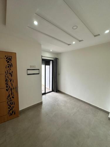 an empty room with white walls and a door at Guilli in Berkane