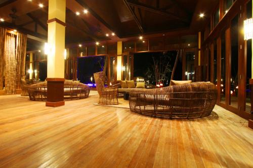 a dance floor with couches and tables in a building at Cauayan Island Resort and Spa in El Nido