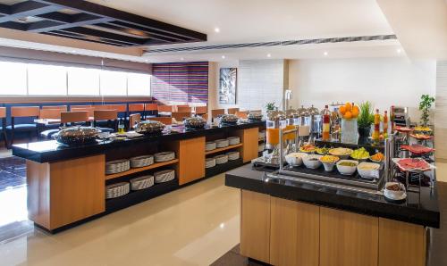 a buffet line with food on display in a restaurant at V Hotel Fujairah in Fujairah