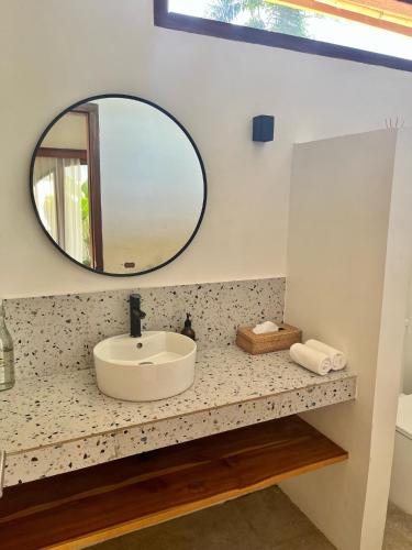 a bathroom with a sink and a mirror at Villa Mila - Gili Air in Gili Air